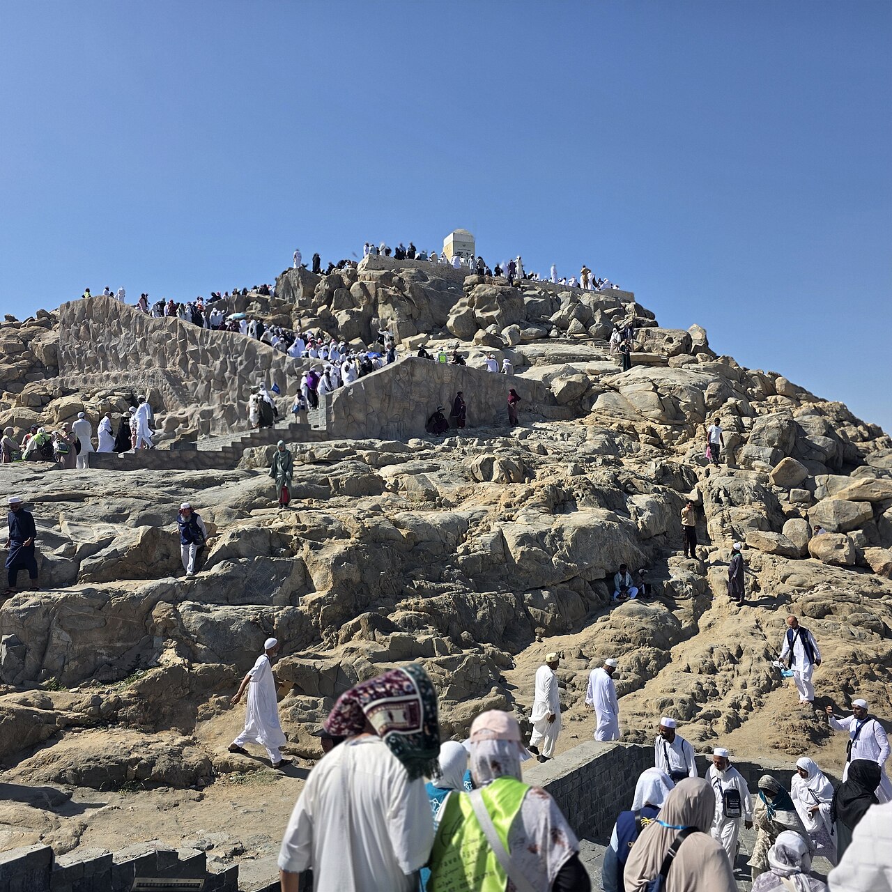Jabal ar-Rahmah at Arafat with visitors on its rocky slopes